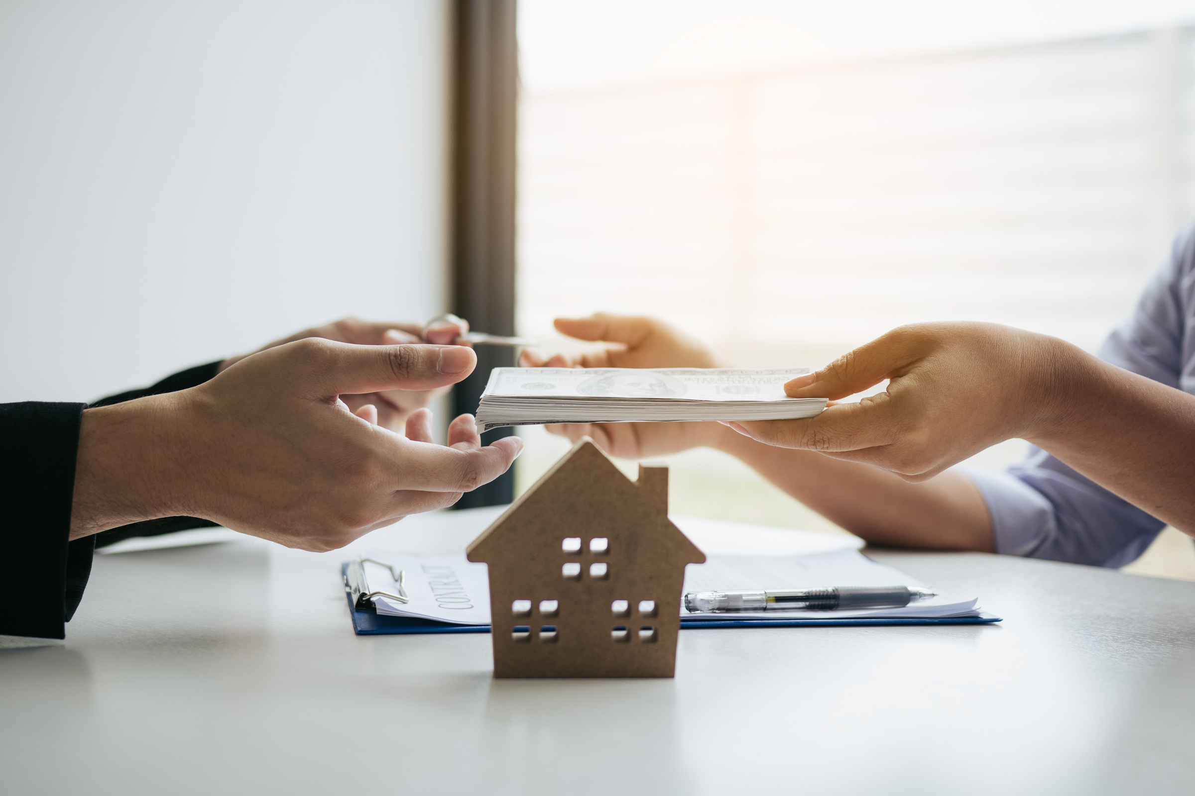 Home Sales Broker and Real Estate Investor Signing 